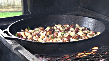 BBQ off the Scottsdale by Arizona BBQ Outfitters. This is a Santa Maria style cooker with a lid that accepts a Cast iron skillet, Cast iron Wok and a cast Iron Griddle. Garlic Red potatoes cooked on the Lodge cast iron skillet on the Scottsdale.
