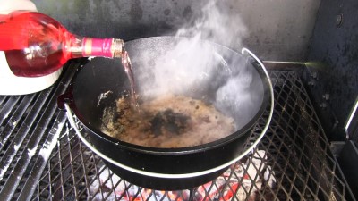 SmokingPit.com - Dutch oven Swiss Steak cooked in a Lodge 12" dutch oven in my Scottsdale Santa Maria style cooker. De-glazing the Dutch Oven with red wine.