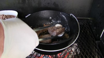 SmokingPit.com - Dutch oven Swiss Steak cooked in a Lodge 12" dutch oven in my Scottsdale Santa Maria style cooker. Browning the meat.
