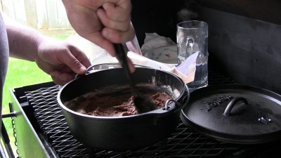 SmokingPit.com - Ditch oven Chocolate Pudding Cake cooked in a Lodge 10" dutch oven in my Scottsdale Santa Maria style cooker. Mixing the cake mix.