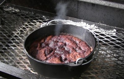 SmokingPit.com - Ditch oven Chocolate Pudding Cake cooked in a Lodge 10" dutch oven in my Scottsdale Santa Maria style cooker. Cake is done and chocolate is bubbling up like lava.
