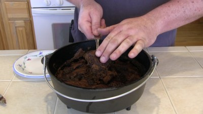 SmokingPit.com - Dutch oven Chocolate Pudding Cake cooked in a Lodge 10" dutch oven in my Scottsdale Santa Maria style cooker. Serving the cake.