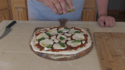 SmokingPit.com - Margherita Pizza recipe wood fire cooked on my Scottsdale Santa Maria style cooker. Putting on the toppings.