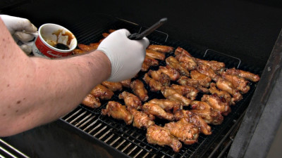 SmokingPit.com - Sesame Soy Chicken Wings.  Slow cooked on the yoder YS640. - Mopping the wings.